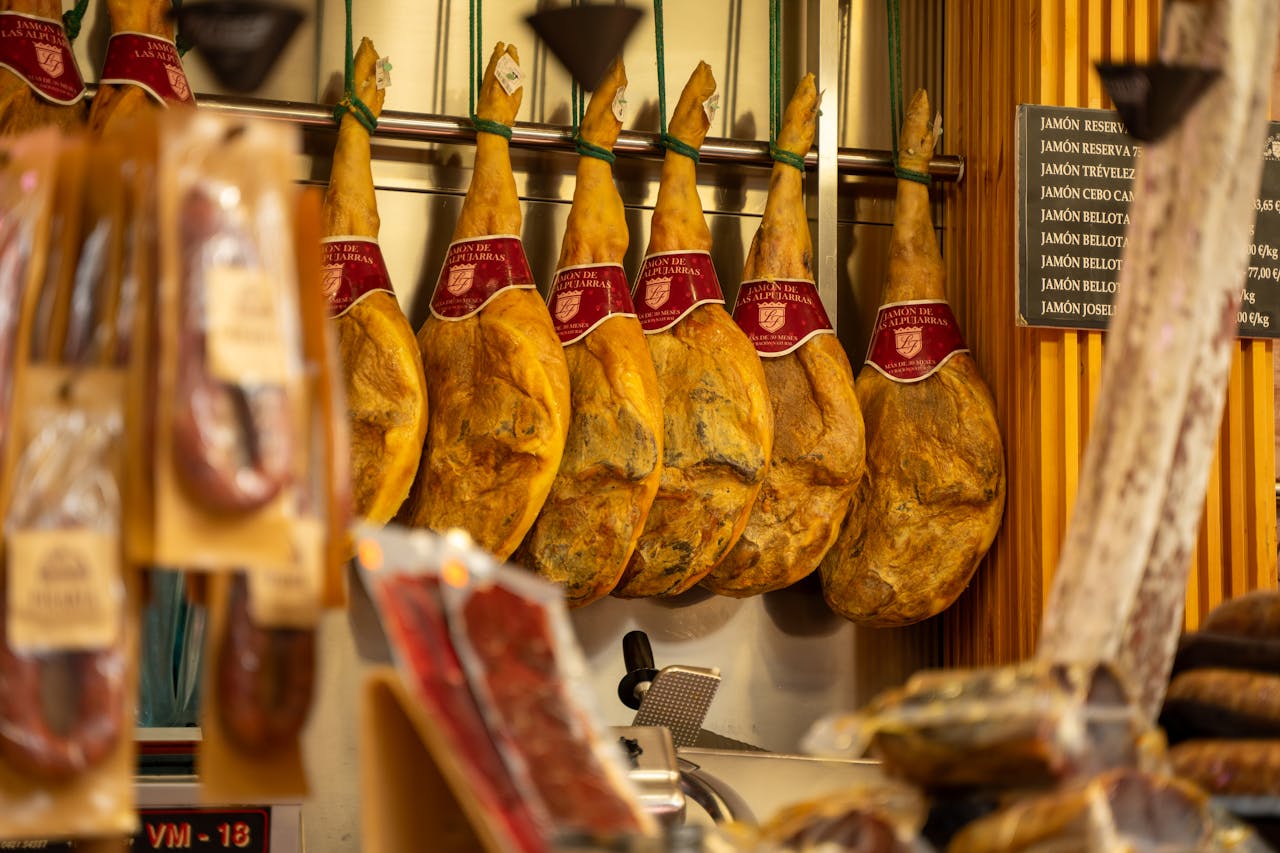 Servizi Close-up of Spanish jamón hanging in a butcher shop in Valencia, Spain.